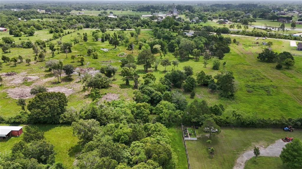 an aerial view of a houses with yard