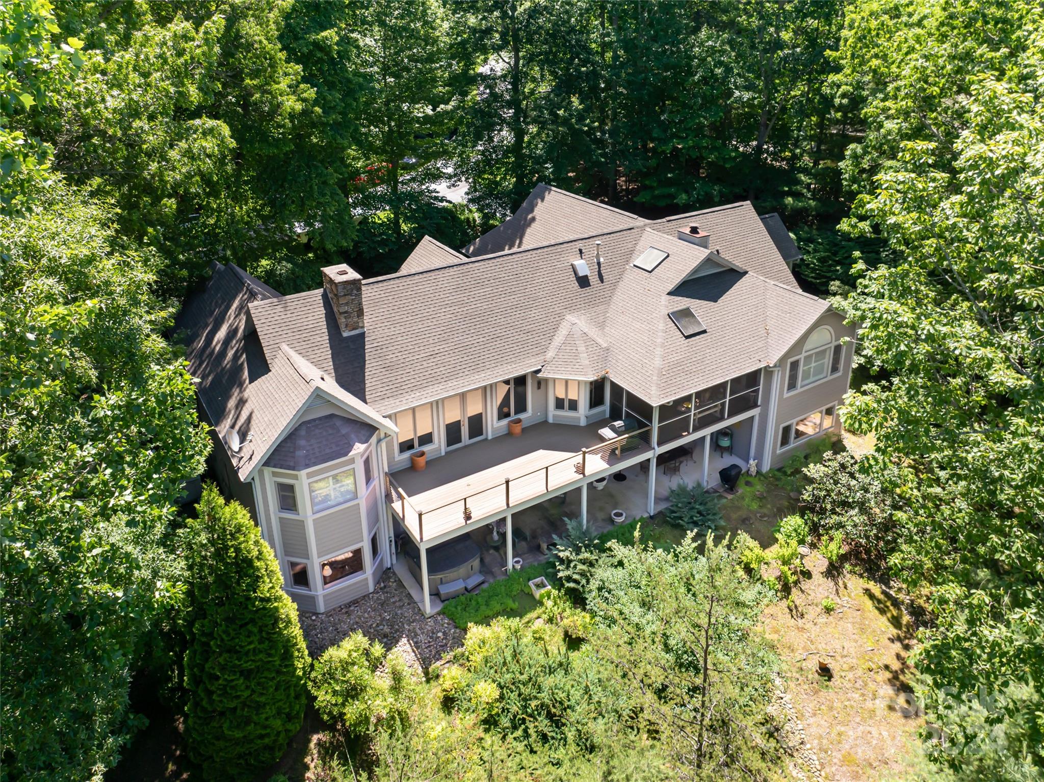 an aerial view of a house with a yard and balcony