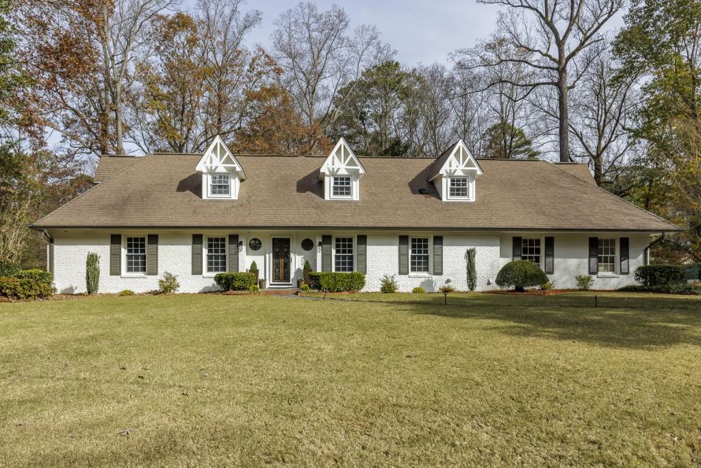 a front view of a house with a garden