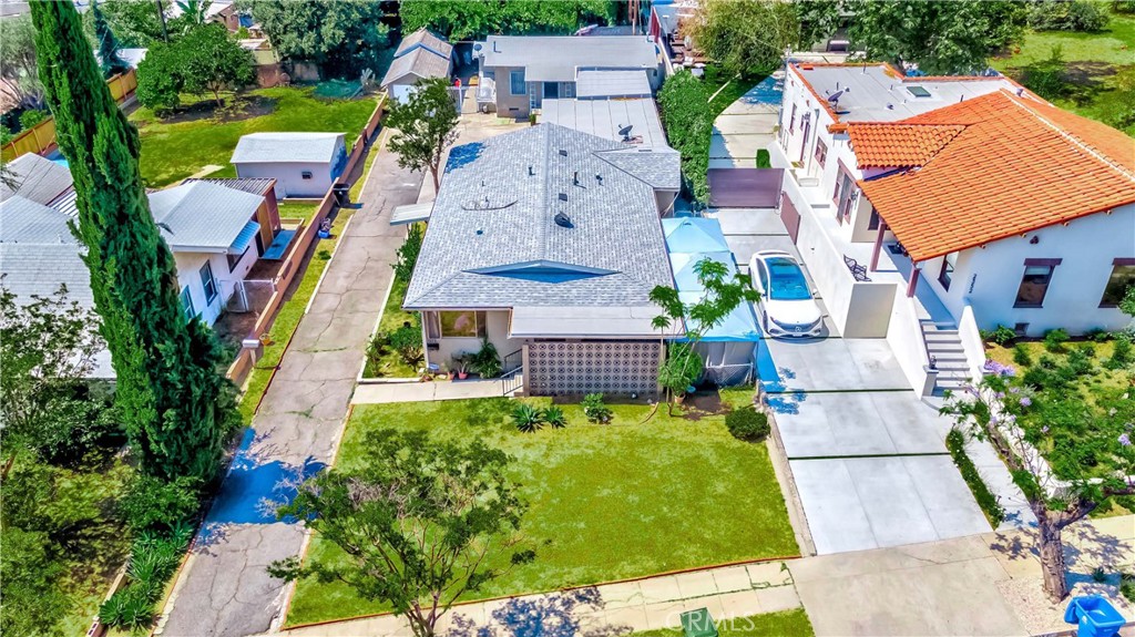 an aerial view of multiple houses with yard