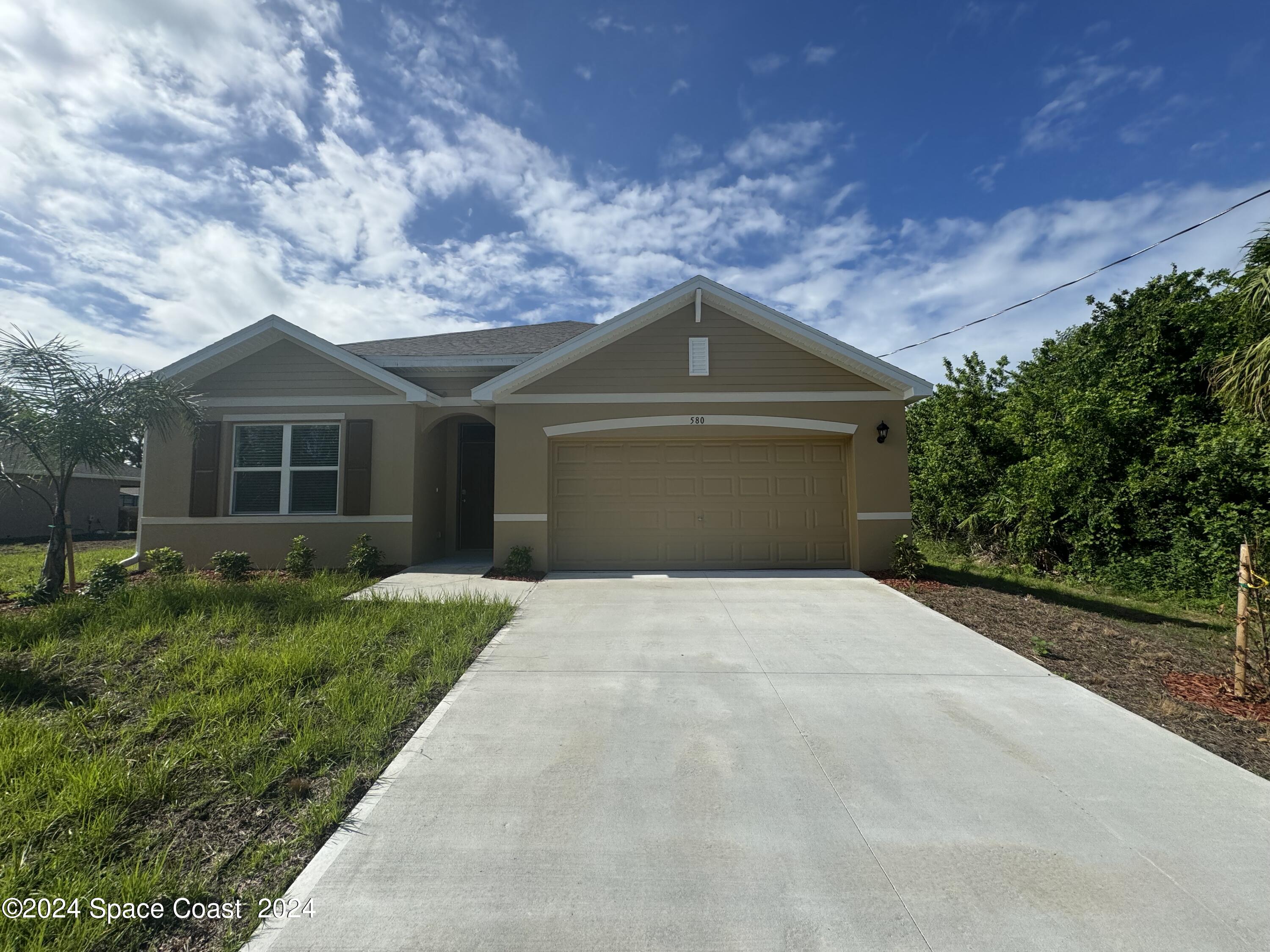 front view of a house with a yard