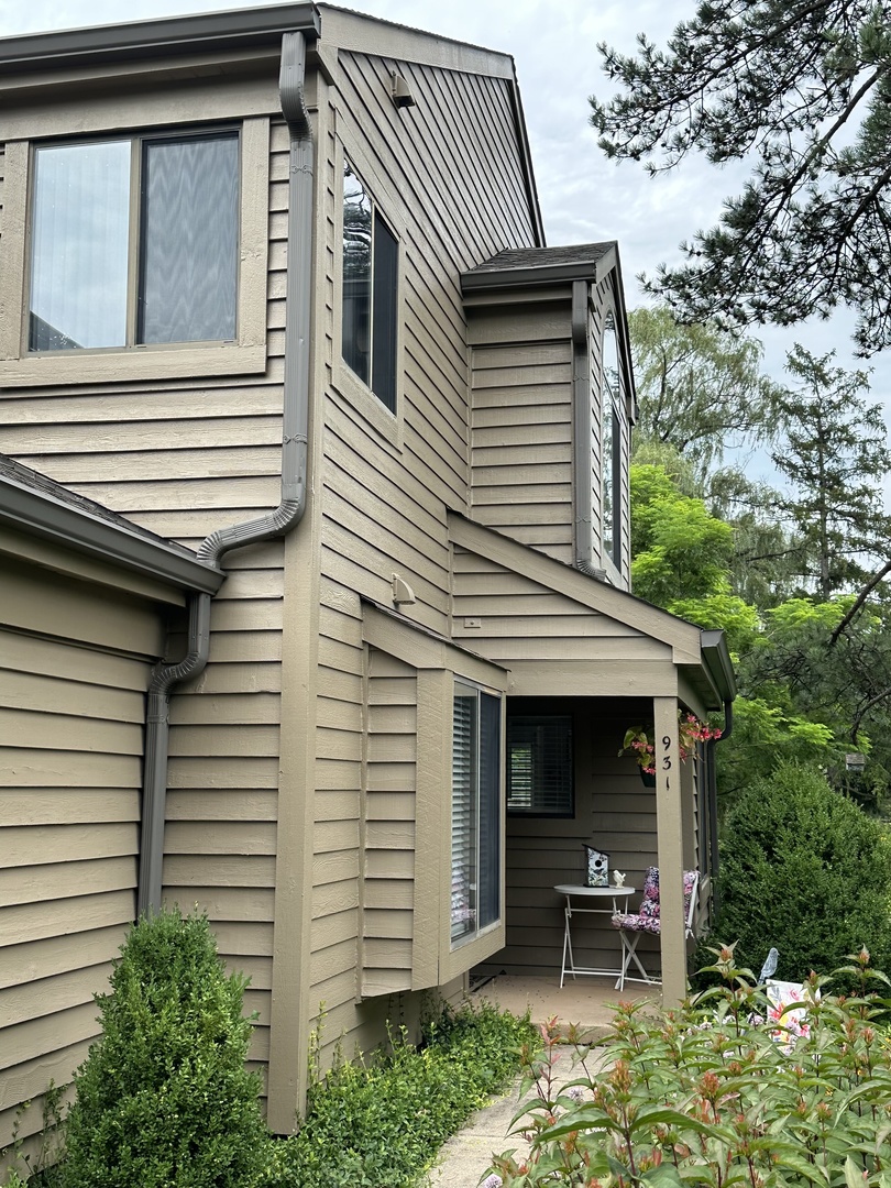 a view of a house with a yard and furniture