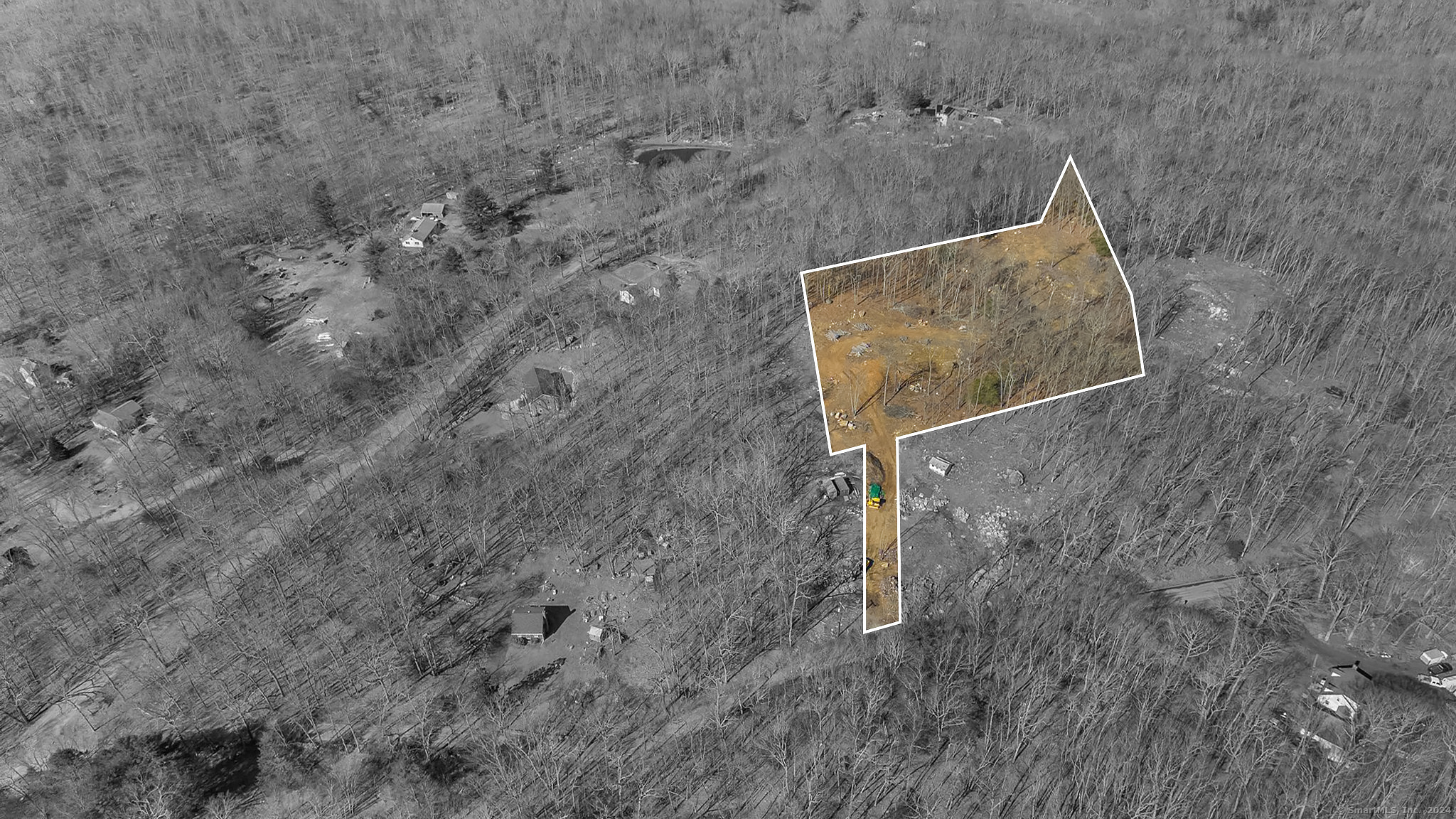 a aerial view of a house with a yard and large tree