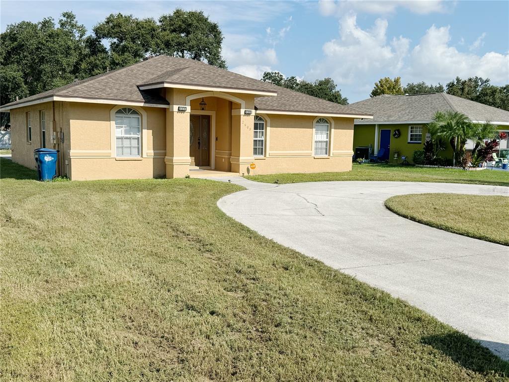 a front view of a house with a garden