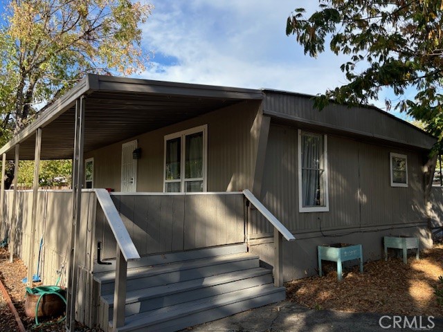 a view of house with roof deck and entertaining space