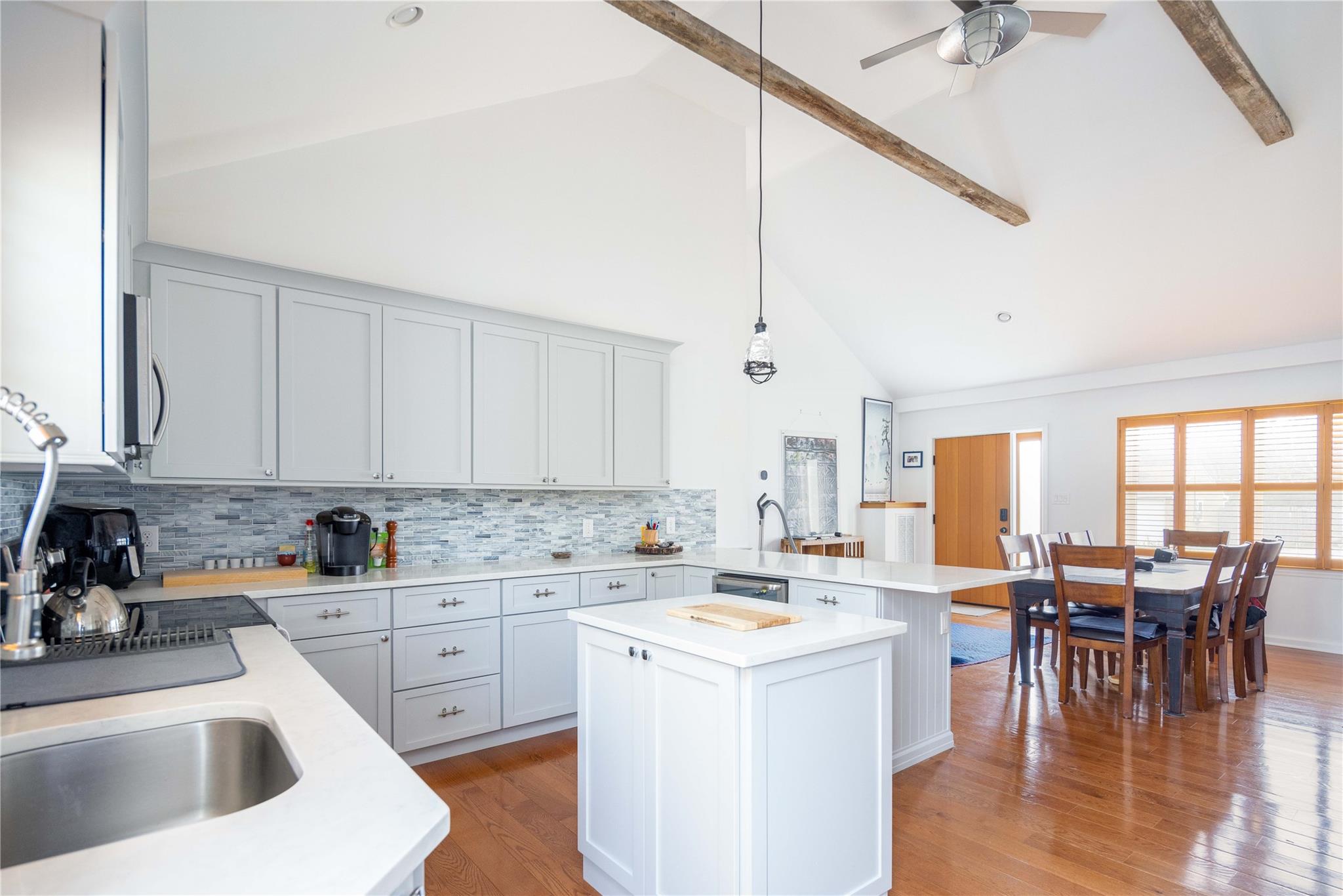 a kitchen with a sink stove and cabinets