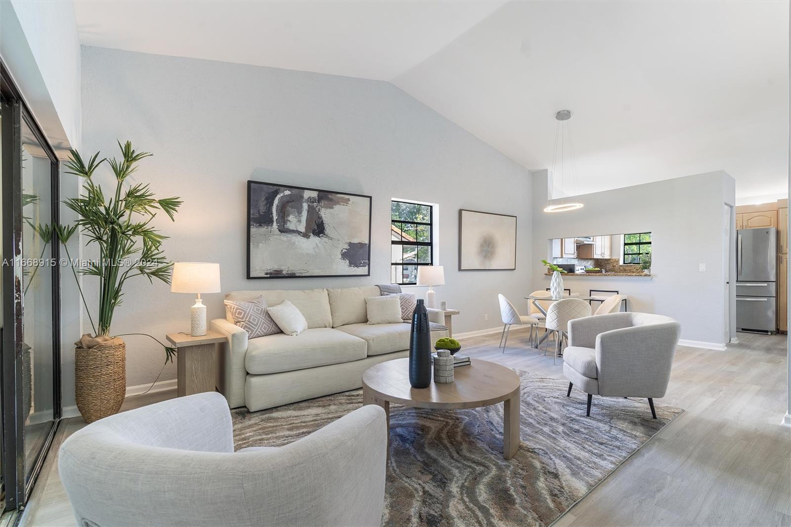 a living room with furniture potted plant and a table