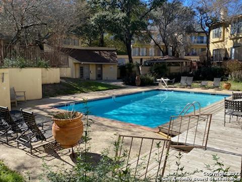 a swimming pool with outdoor seating and yard