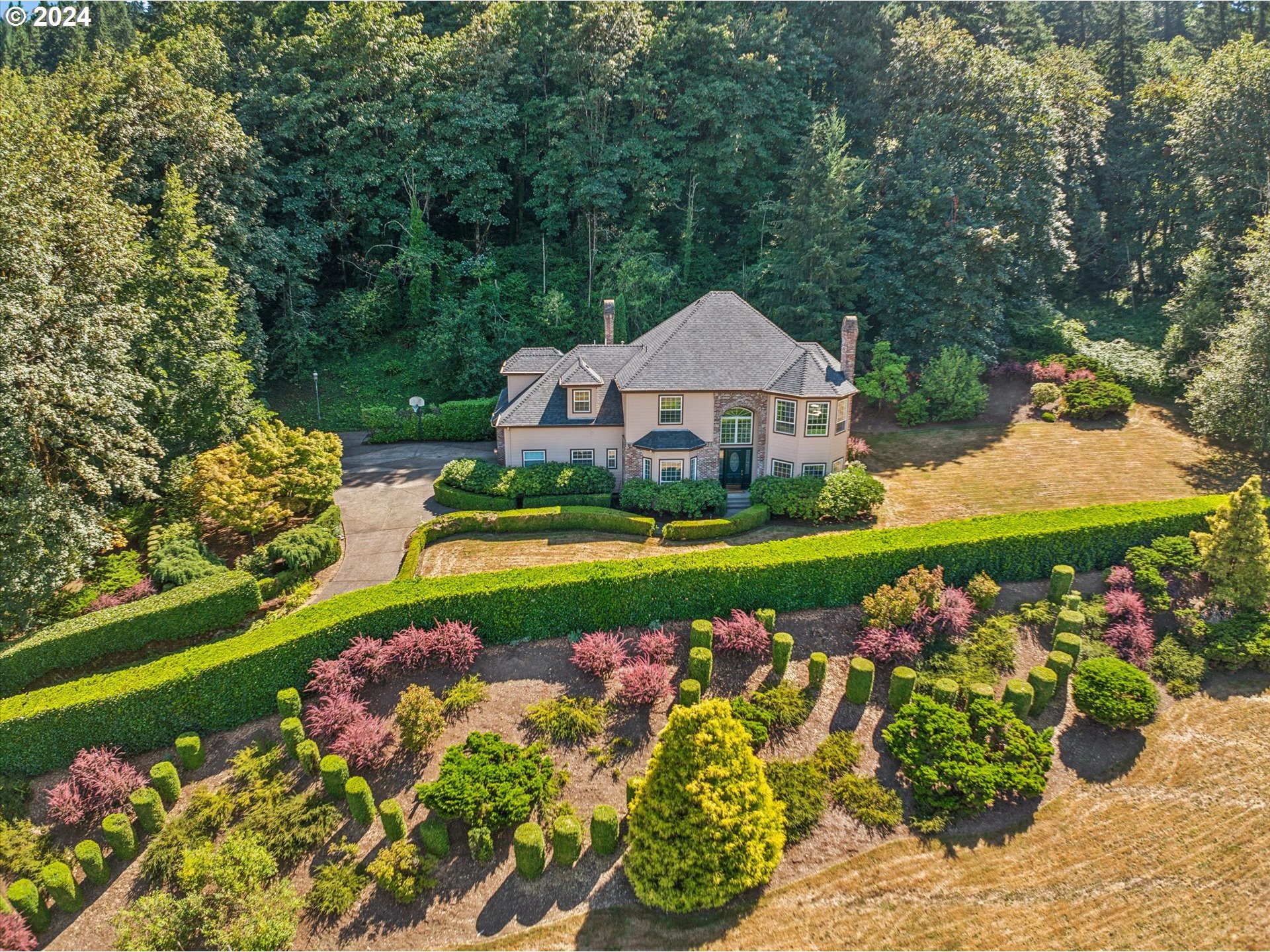 a view of a house with a big yard and garden