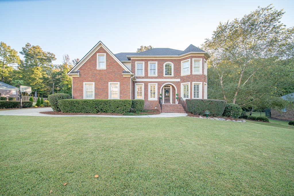 a front view of a house with garden