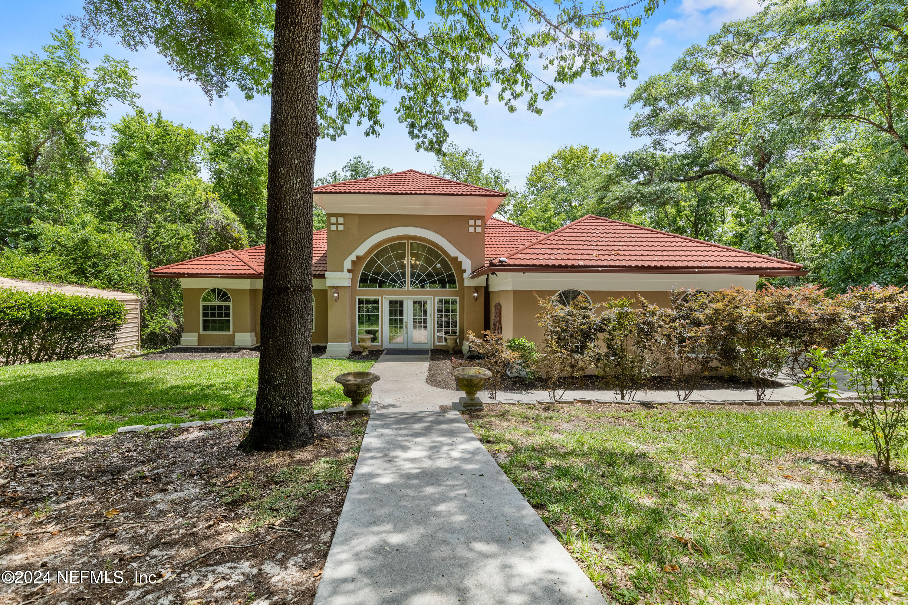 a front view of a house with garden