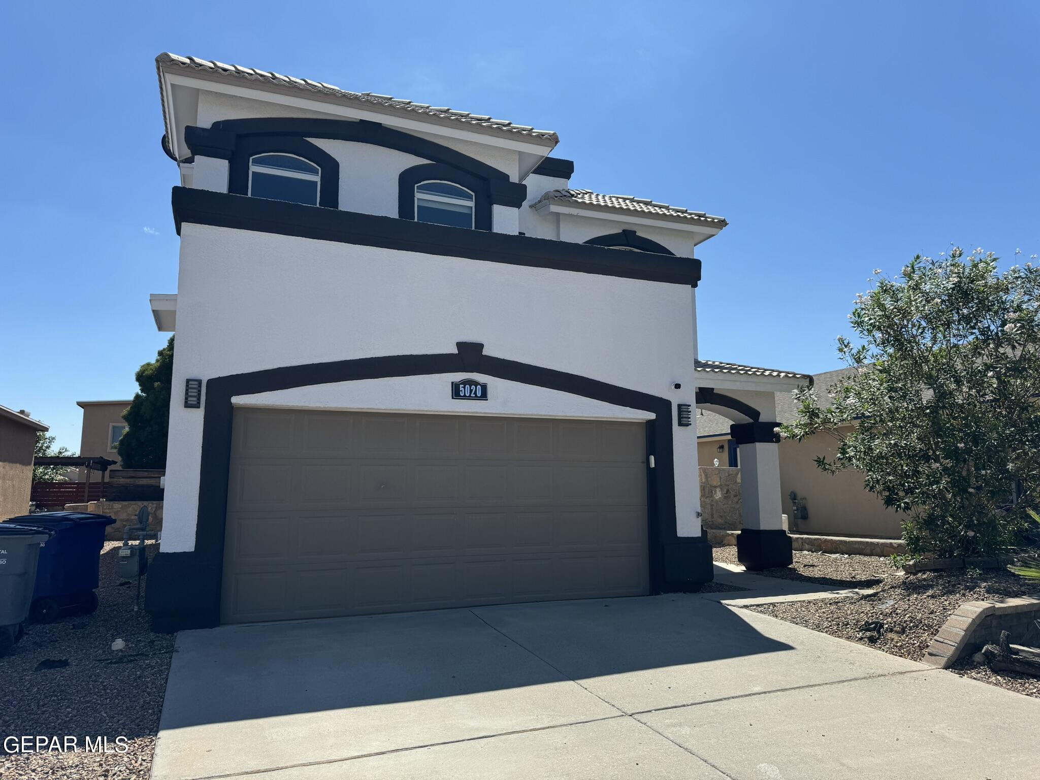 a front view of a house with parking space