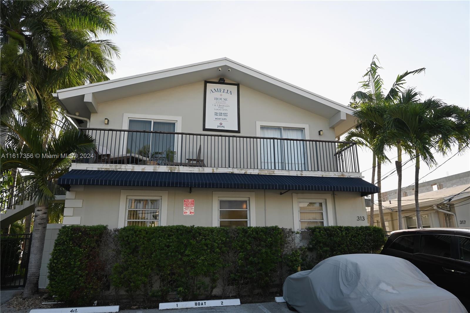 a house that has a lot of windows and palm tree