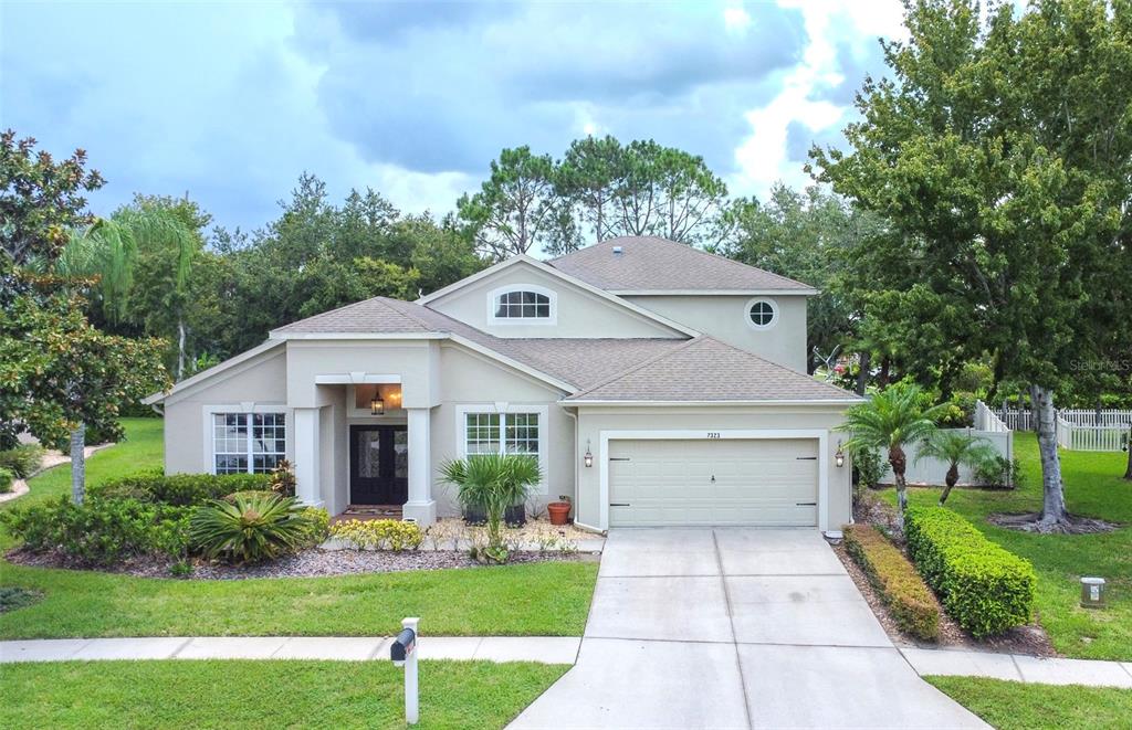 a front view of a house with a yard and garage