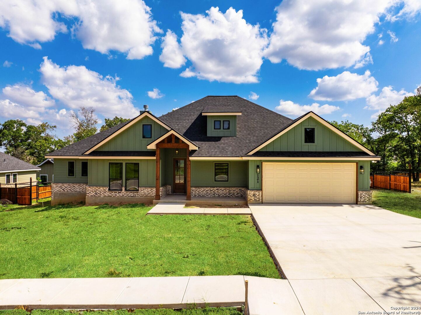 a front view of house with yard and green space