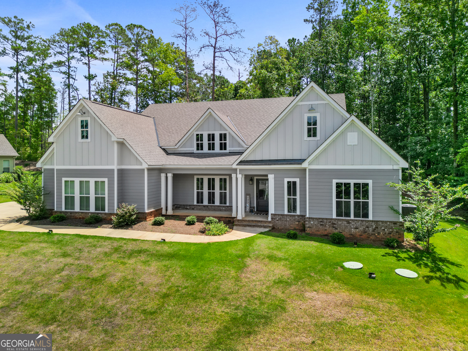 a front view of a house with garden