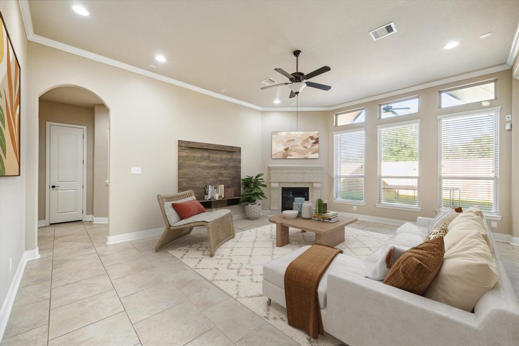 a living room with furniture fireplace and a large window