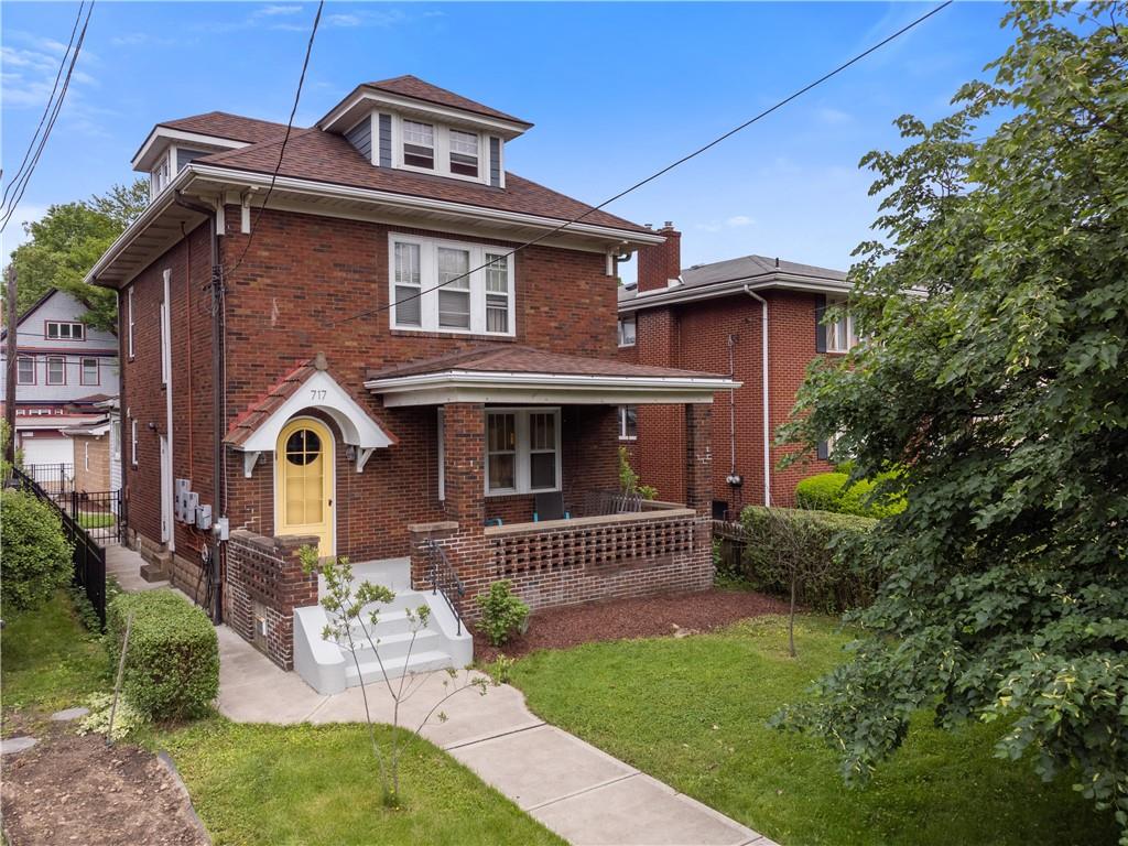 a front view of a house with garden