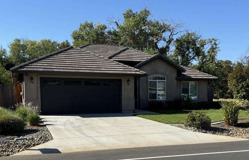 a front view of a house with a garden