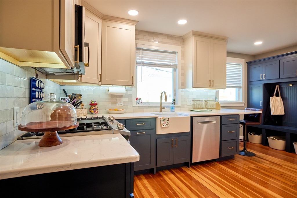 a kitchen with a sink appliances and cabinets