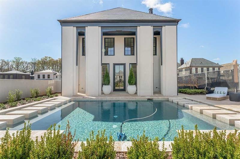 a view of a house with backyard and sitting area