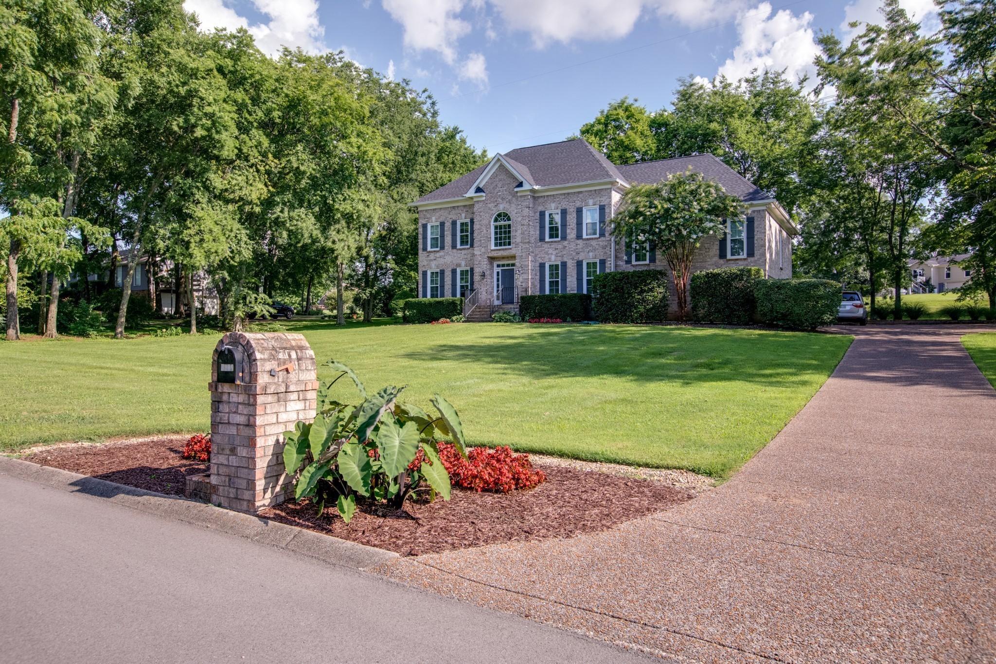 a view of a house with a yard and a park