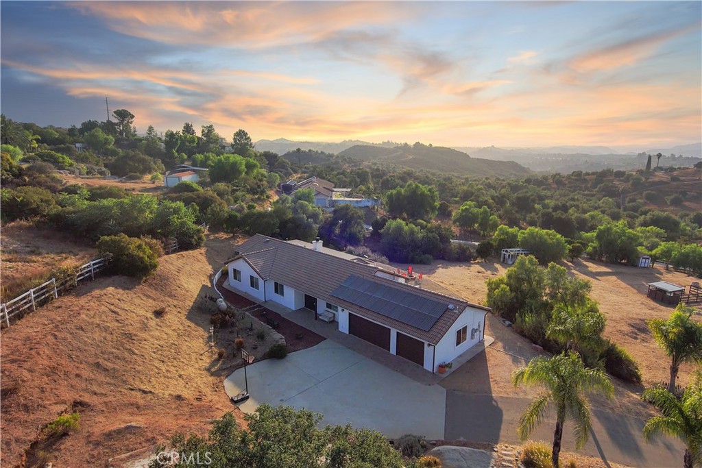 an aerial view of a house with a mountain view