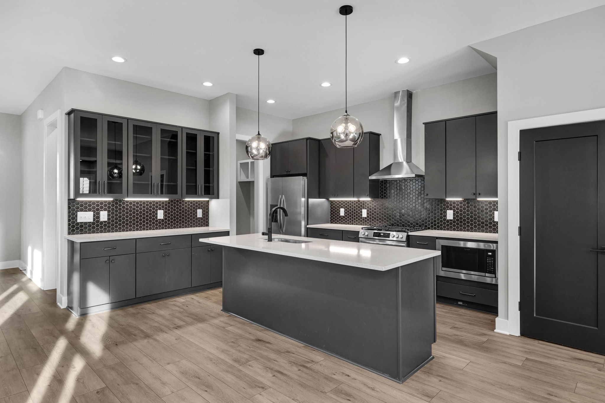 a large kitchen with cabinets and stainless steel appliances