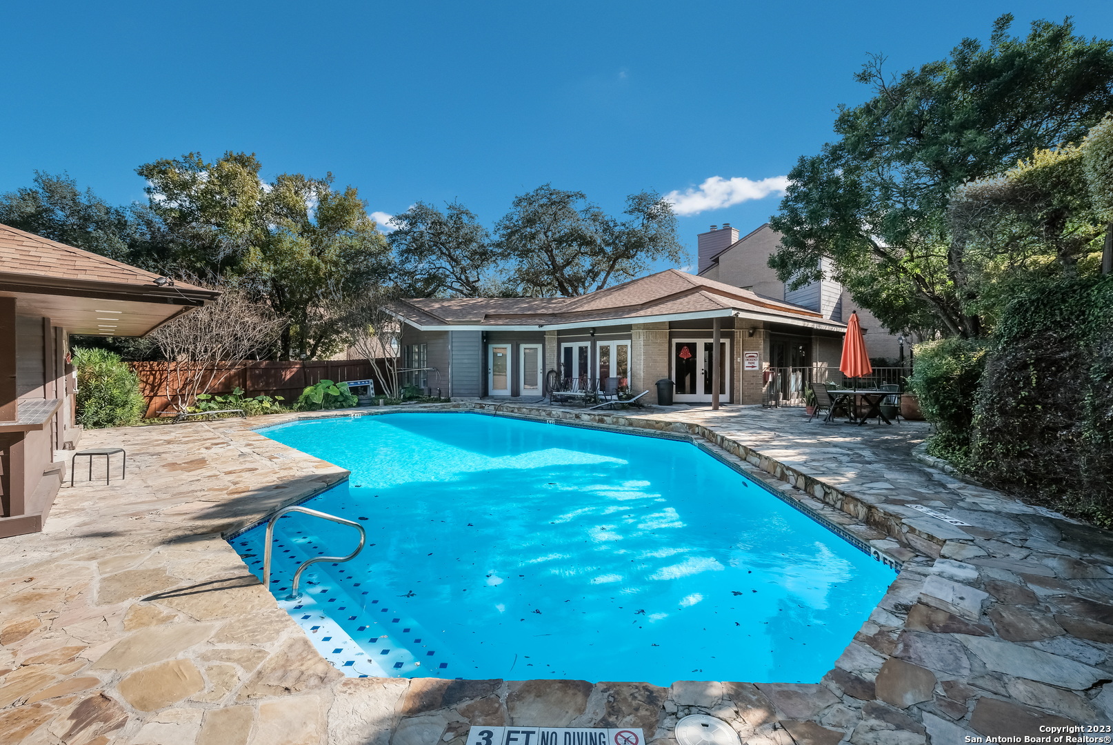 a view of house with swimming pool outdoor seating