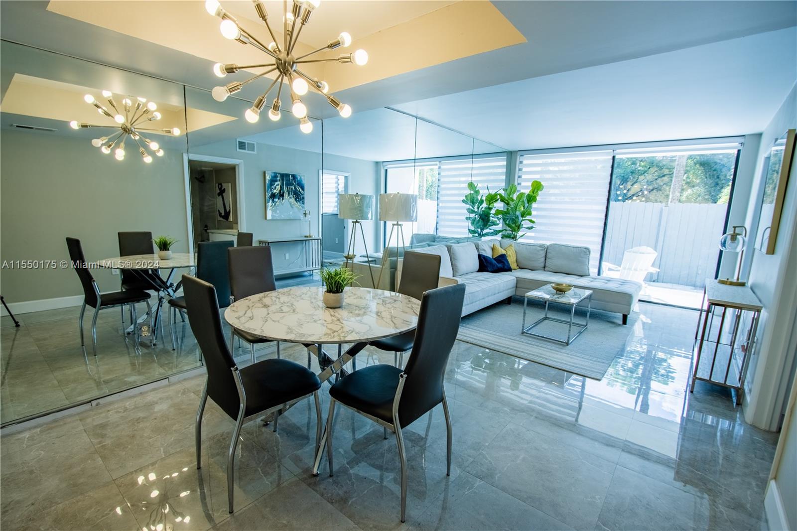 a view of a dining room with furniture and a chandelier