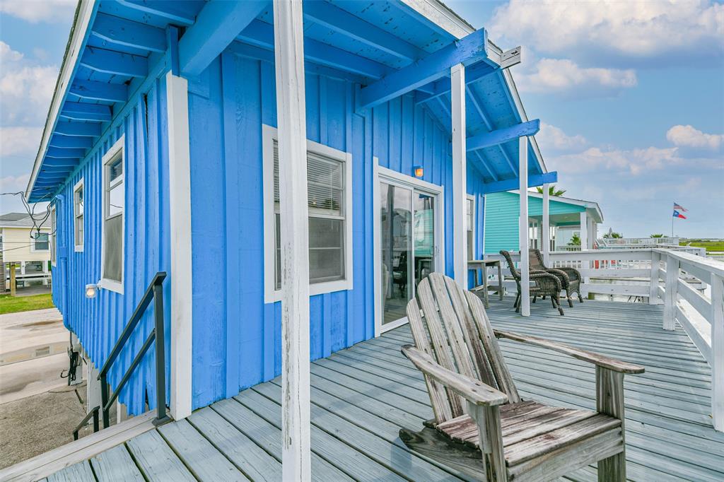 a view of balcony with two chairs and wooden floor