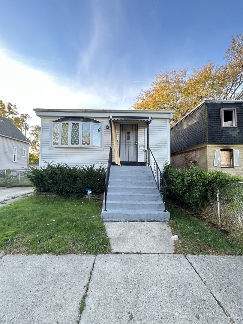 a front view of a house with a yard and a garage