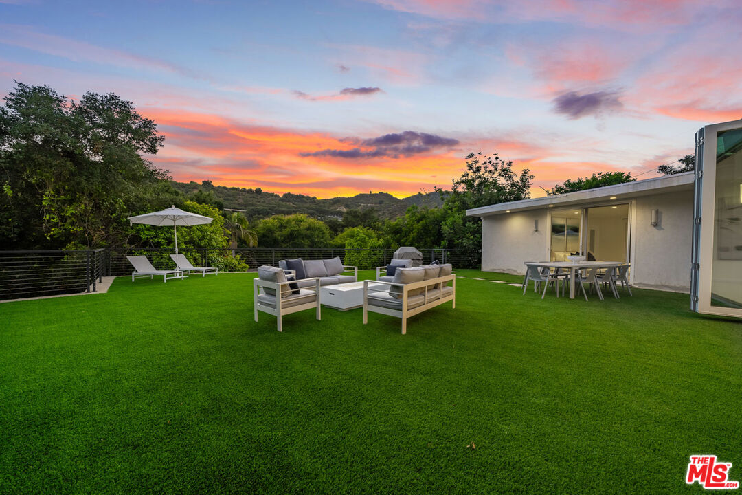 a view of a patio with table and chairs and potted plants with sky view