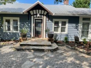 a view of house with outdoor space and porch