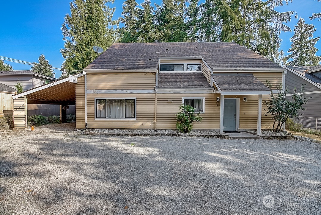 a front view of a house with a yard and a garage