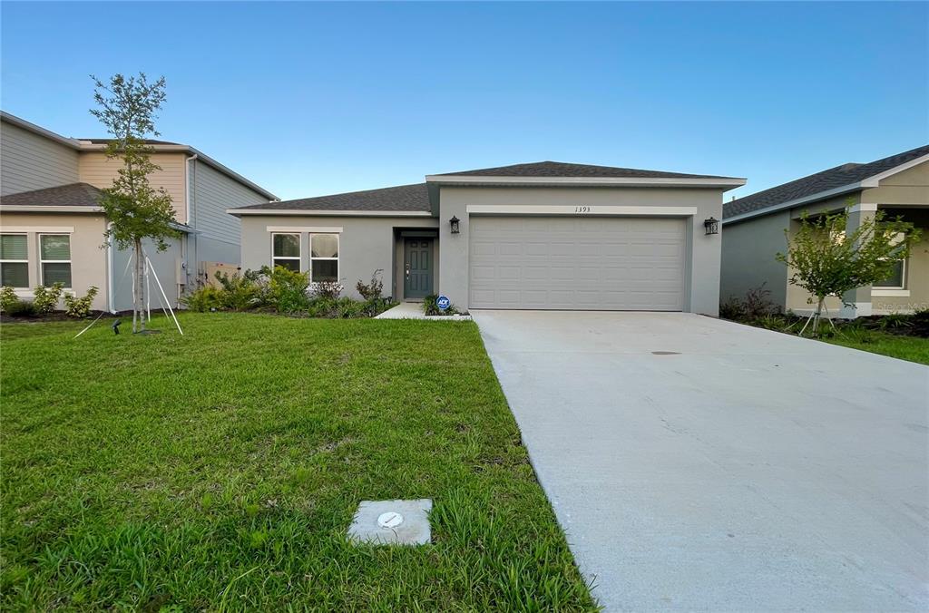 a front view of a house with a yard and garage