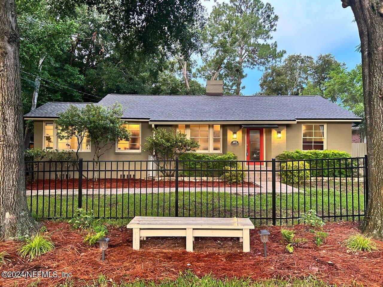 a view of a house with a backyard