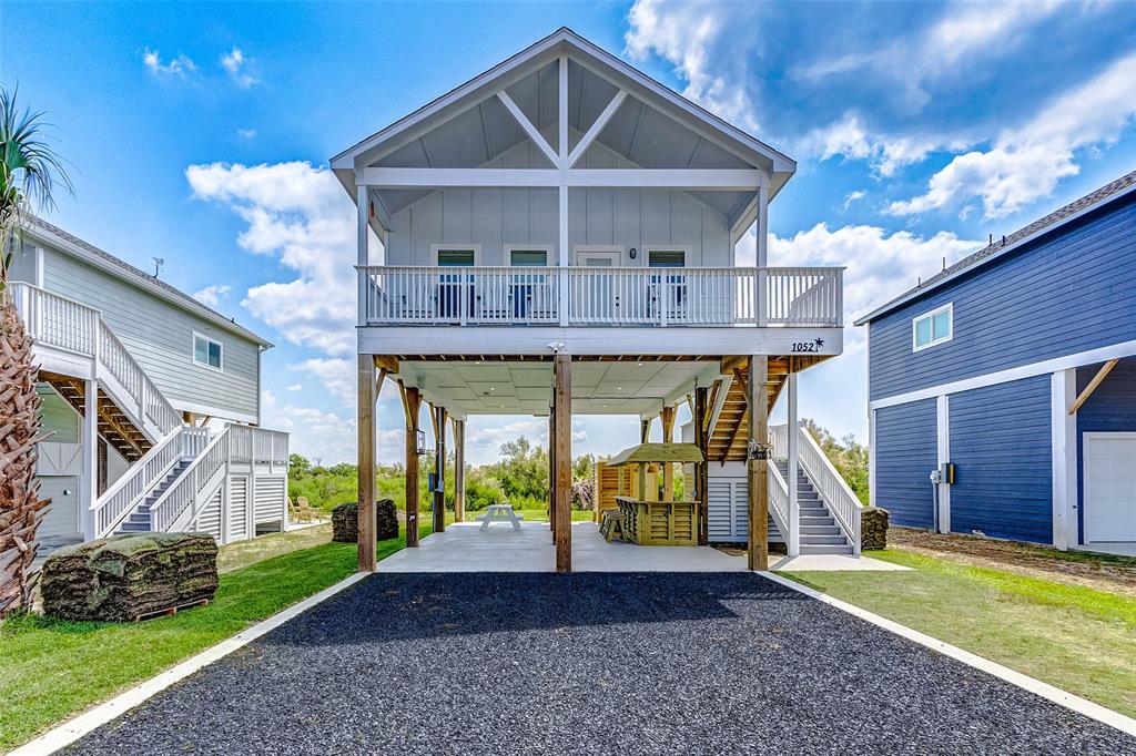 a view of a house with a yard and balcony