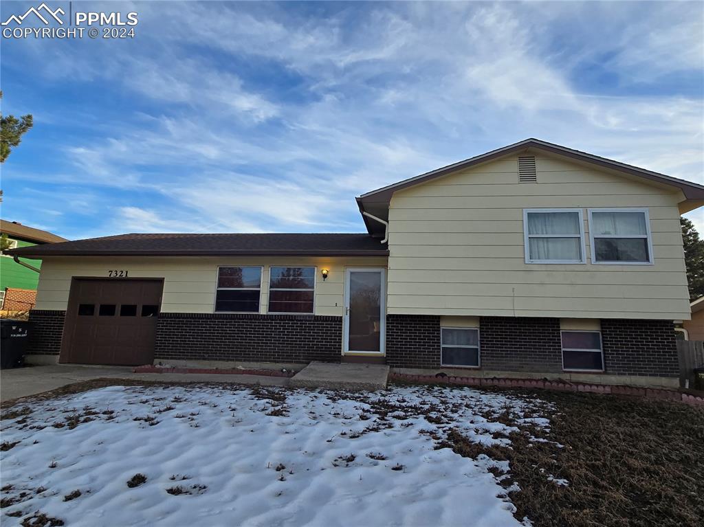 Split level home featuring a garage