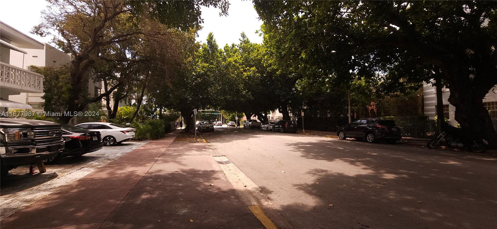 a view of street with parked cars