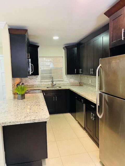 a kitchen with a sink and a refrigerator