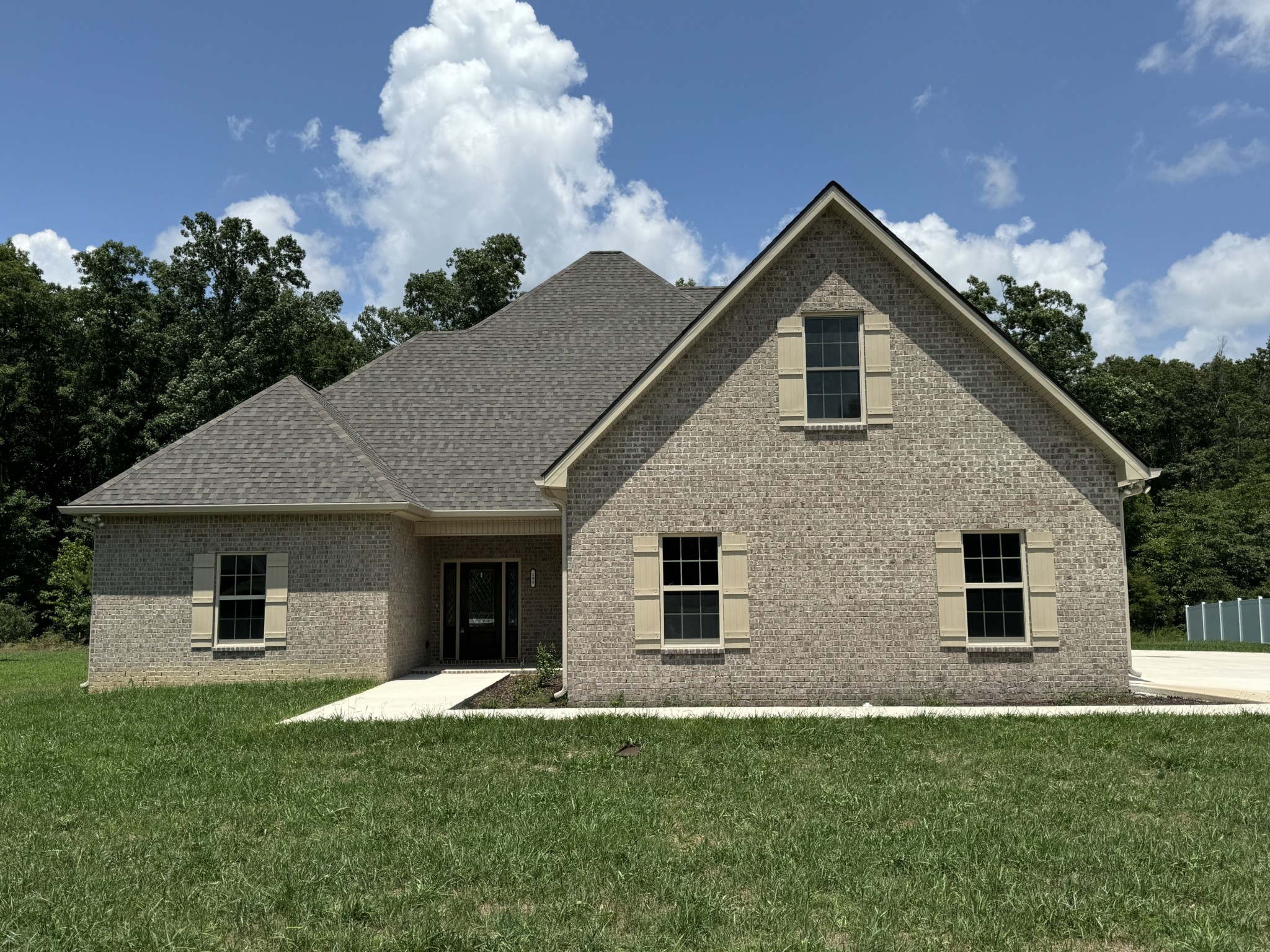 a front view of a house with a yard