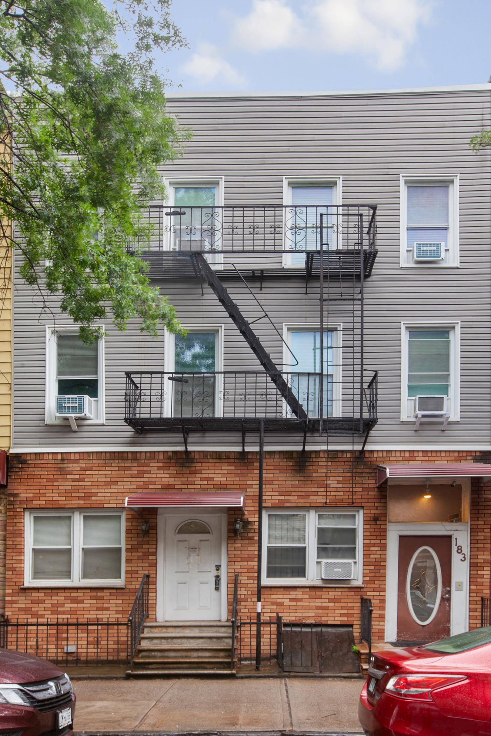 a view of a house with a balcony and door