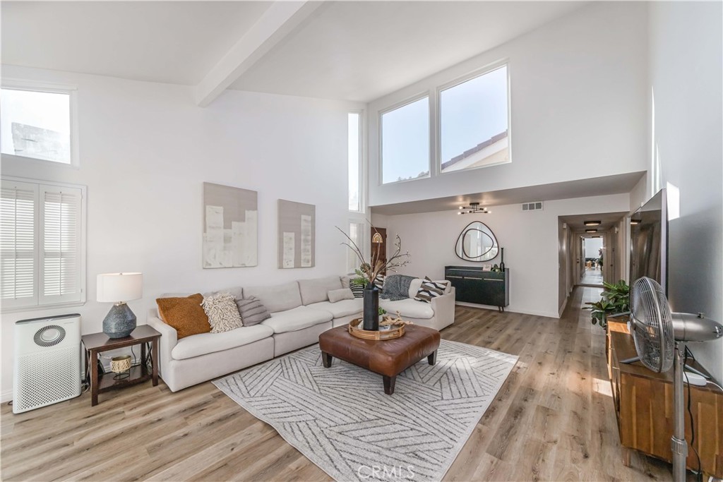 a living room with furniture and a clock