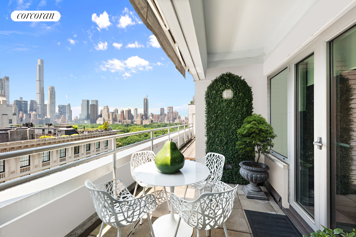 a balcony with furniture and a potted plant