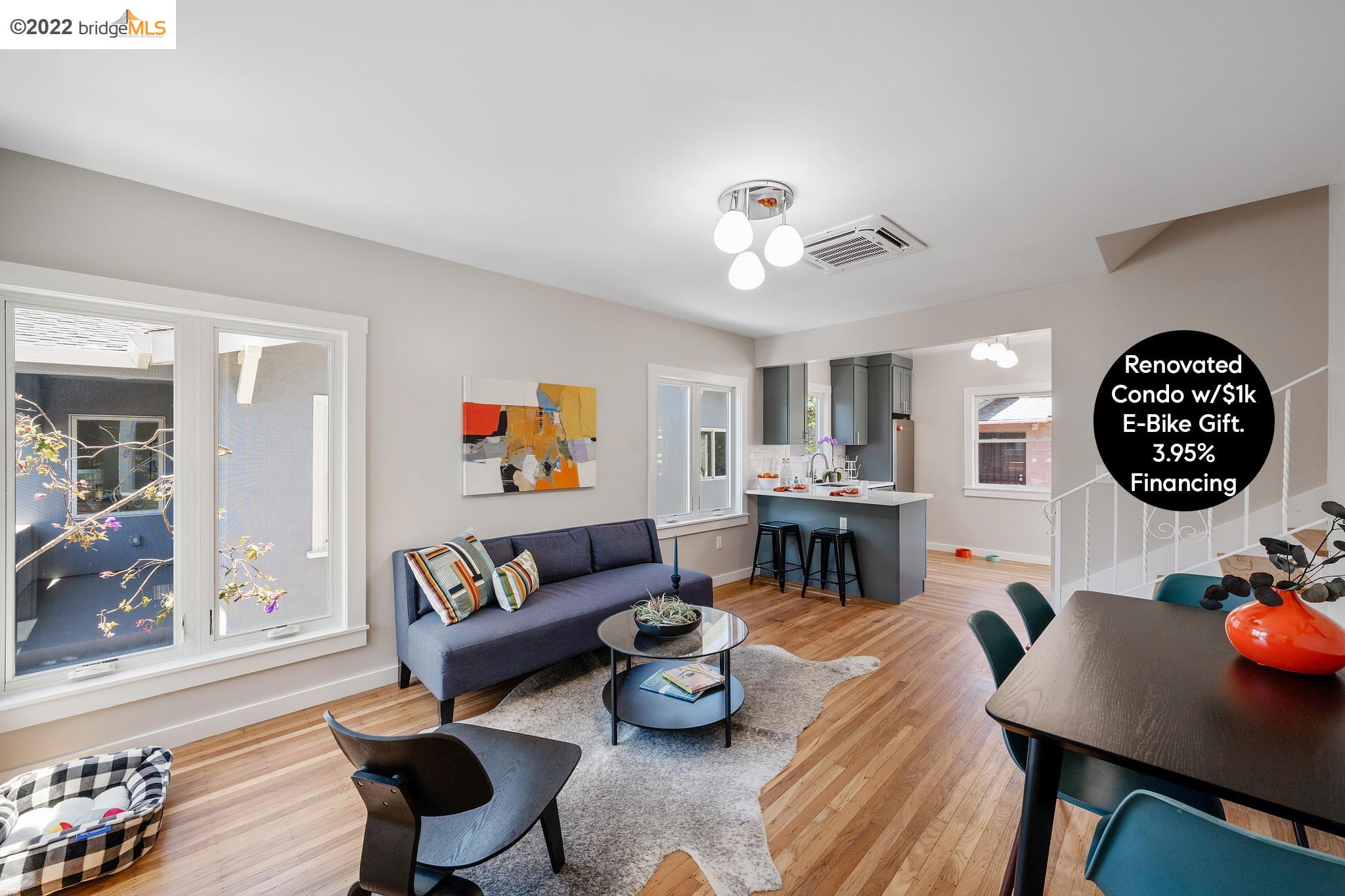 a living room with furniture kitchen view and a table