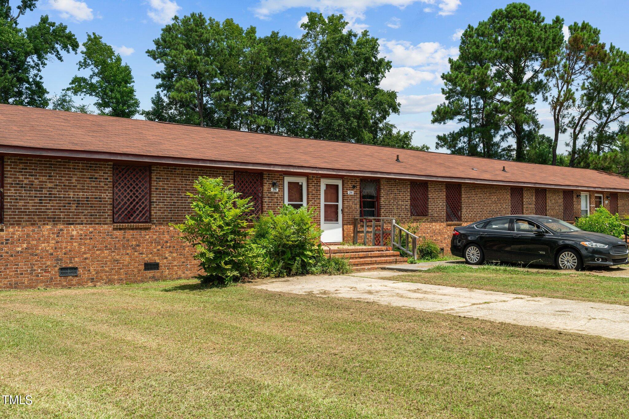 a front view of a house with garden