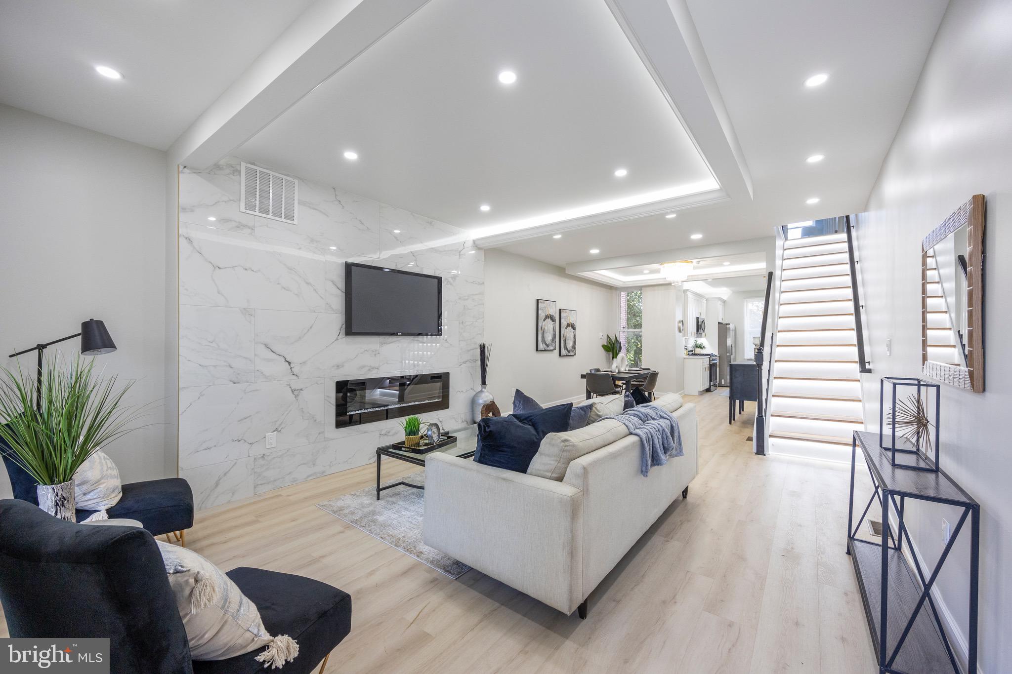 a living room with fireplace furniture and a flat screen tv