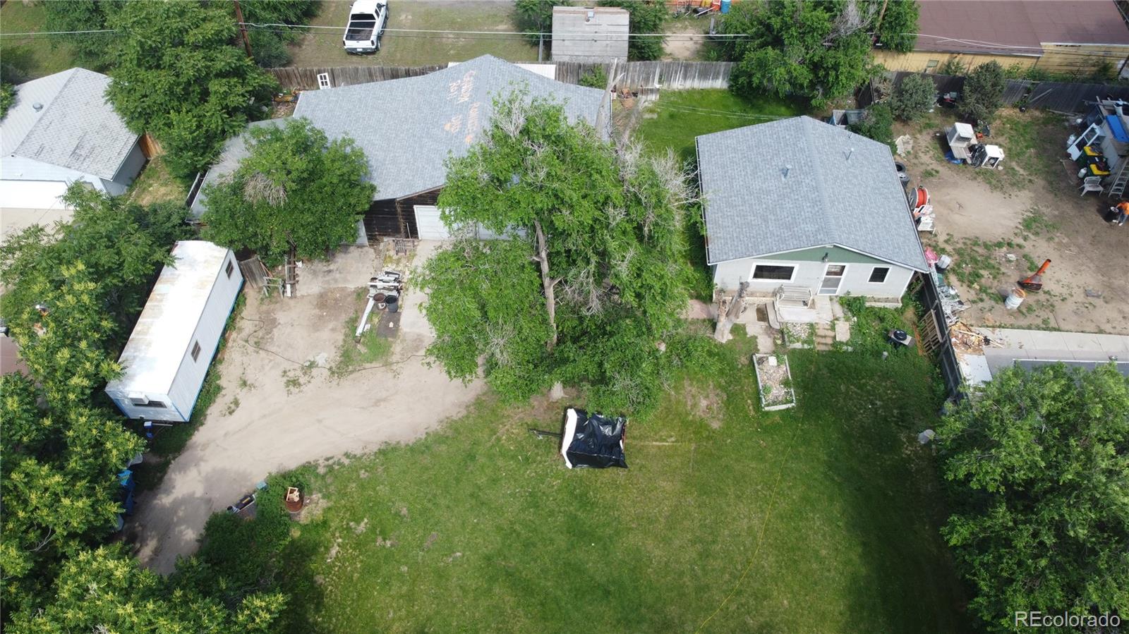 an aerial view of a house with outdoor space patio and trees all around