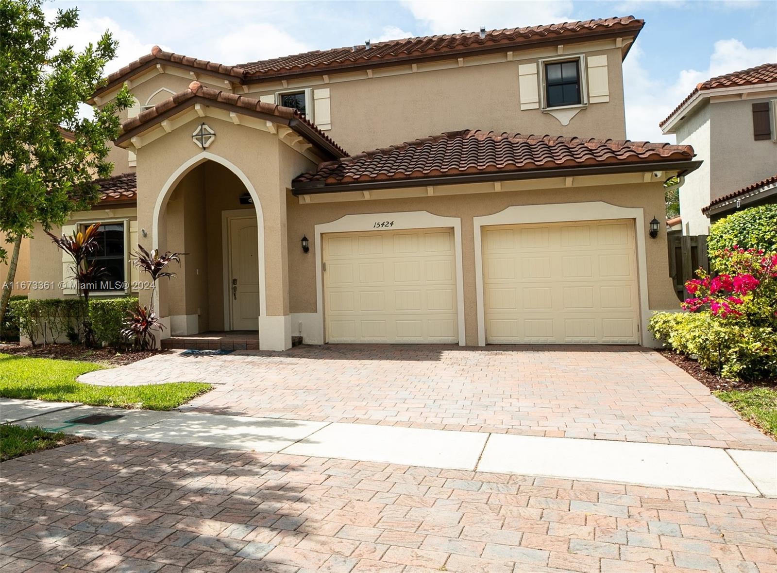 a front view of a house with garden